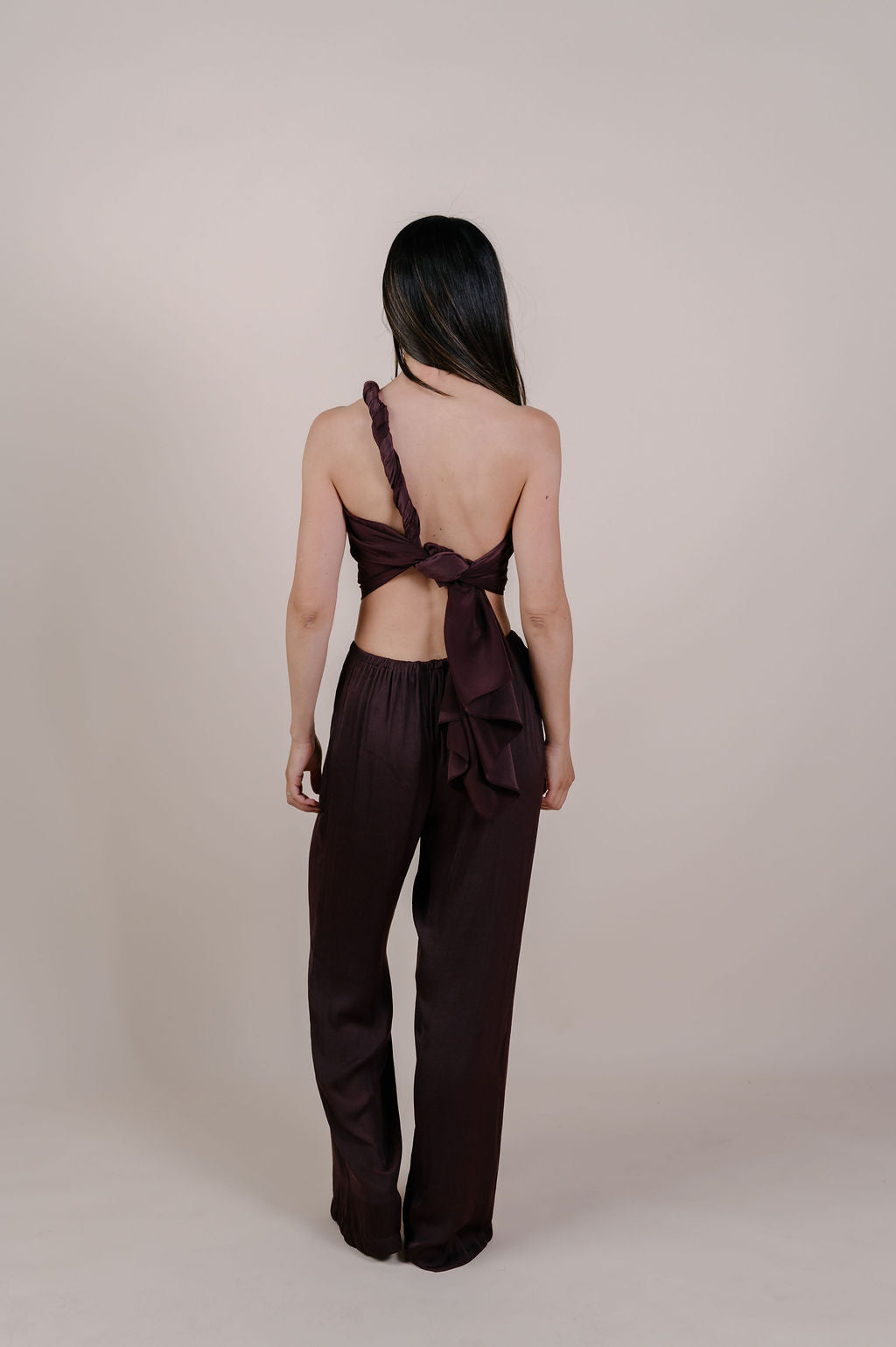 Model wearing the Noa solid chocolate silk pareo by Novo Pareo. 100% Mulberry Silk Twill in deep chocolate brown, minimalist and timeless design for refined Australian resort wear.
