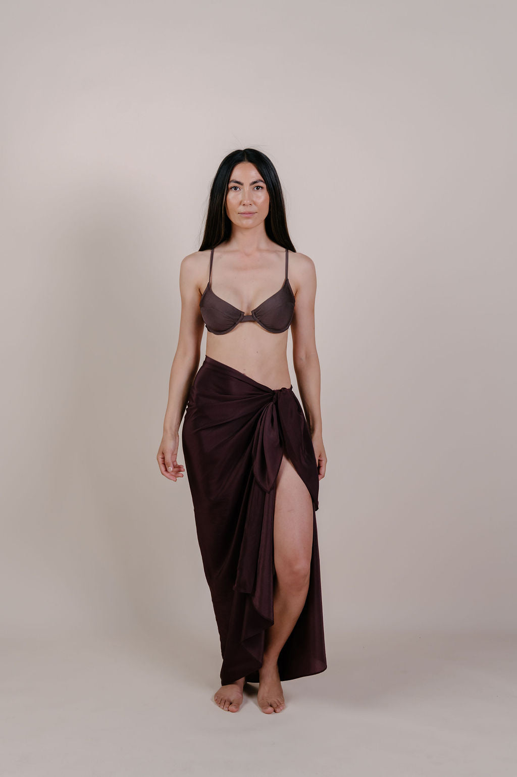 Model wearing the Noa solid chocolate silk pareo by Novo Pareo. 100% Mulberry Silk Twill in deep chocolate brown, minimalist and timeless design for refined Australian resort wear.